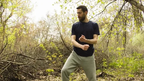 Young man practicing karate in the spring forest. Stock-Footage 80694969
