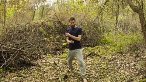 Young man practicing karate in the spring forest. 스톡 동영상 80698901