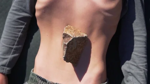 Young man practicing the movement of the abdomen nauli yoga technique Stock Footage 124525920