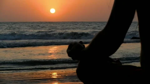 Young man practicing relaxation exercises by the sea Stock Footage 94127033
