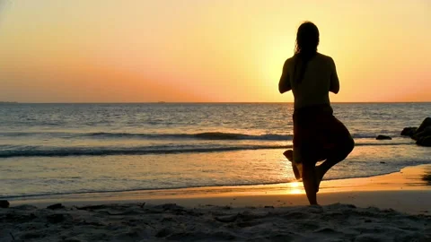Young man practicing relaxation exercises by the sea Stock Footage 94127120