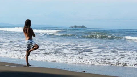 Young Man Practicing Relaxation Yoga Exercises by the Sea Stock Footage 100089960