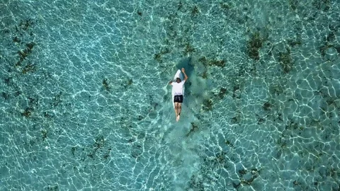 Young man is practicing surfing Shoot footage from aerial view to drone. Stock Footage 96311597