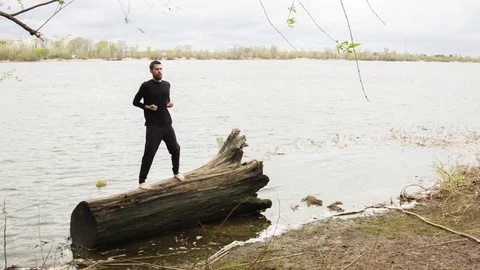 Young man practicing wing chun near the river Video stock 80699262
