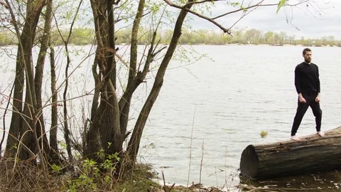 Young man practicing wing chun near the river Stock-Footage 80699377