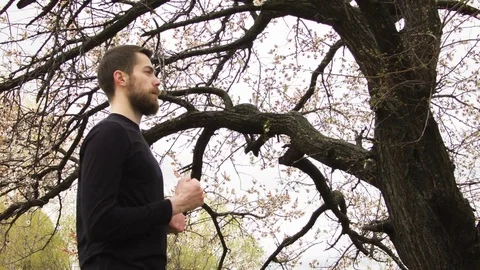 Young man practicing wing chun near the river Stockbeeldmateriaal 80699486