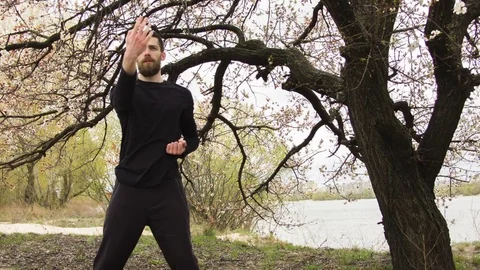 Young man practicing wing chun near the river Stock-Footage 80731018