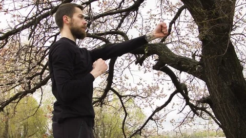 Young man practicing wing chun near the river Видео 80735187