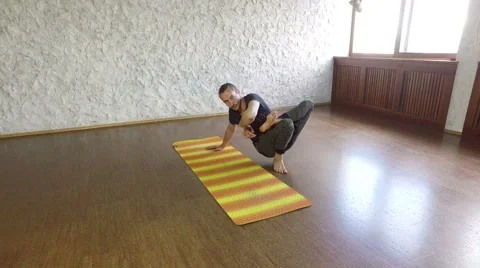 The young man practicing yoga in the hall. Asana on the balance. 4K Vidéo 66300224