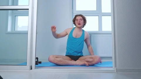 Young man practicing yoga at home Stock Footage 125993010