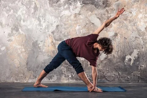 Young man practicing yoga Stock Photos
