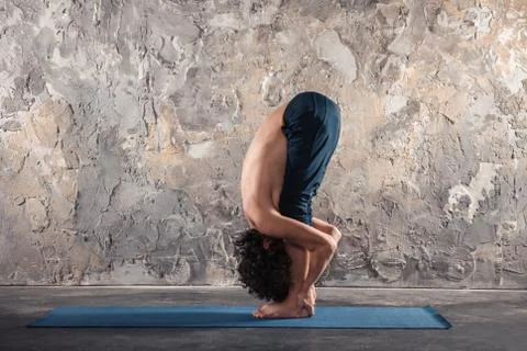 Young man practicing yoga Stock Photos
