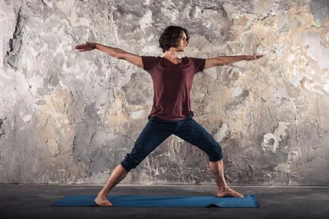 Young man practicing yoga Stock Photos