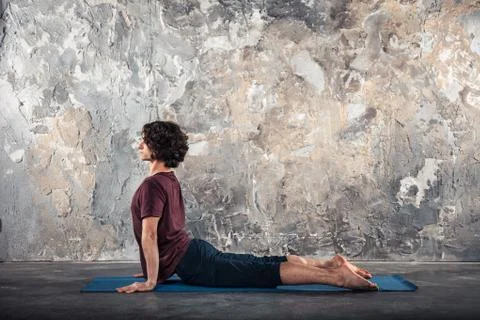 Young man practicing yoga Stock Photos