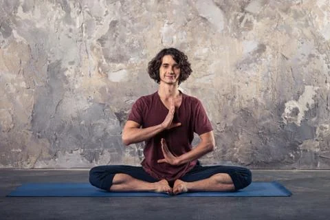 Young man practicing yoga Stock Photos