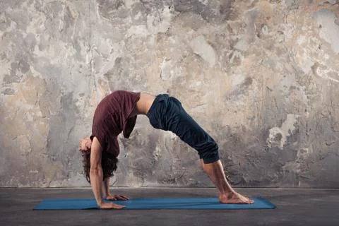 Young man practicing yoga Stock Photos