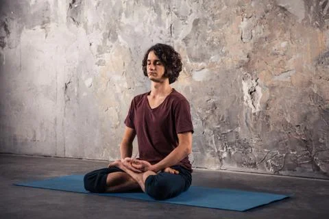 Young man practicing yoga Stock Photos