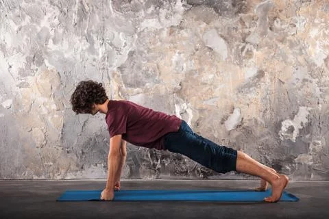 Young man practicing yoga Stock Photos