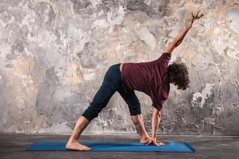 Young man practicing yoga Stock Photos