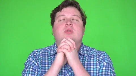 Young man praying on green screen Stock Footage 83601362