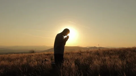 Young Man Praying on a Hill Stock Footage 55837910