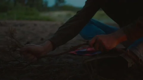 Young man prepare to make campfire on hiking date Stock Footage 205367014