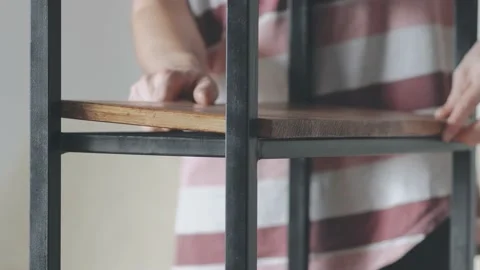 Young man prepares items to assemble a loft table Vidéo 145182504