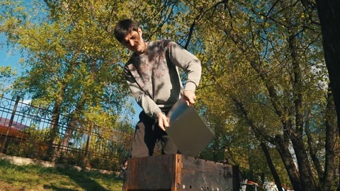 Young man preparing a barbecue in the garden Stock Footage 107589324