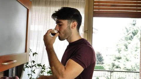 Young man preparing coffee with machine at home Stock Photos