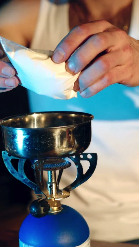 Young man preparing dose of crack cocaine.  Stock Footage 290038508