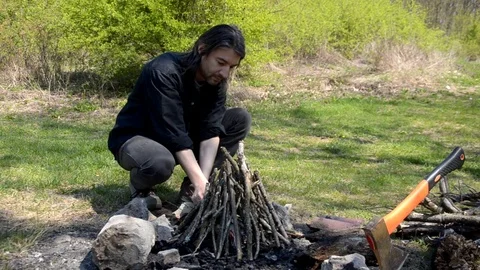 Young man preparing fireplace Stock Footage 71289088