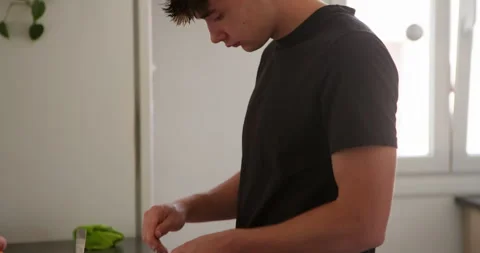 Young man preparing food: Stock Footage 336140811