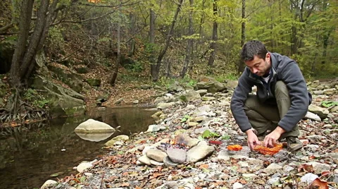 Young man Preparing food steaks and sausages on camping fire. 스톡 동영상 56881013