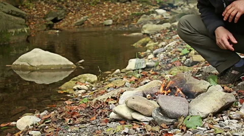 Young man Preparing food steaks and sausages on camping fire. 库存影片 56881429