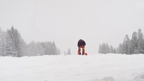 A young man preparing his snowboard for riding Stock Footage 263016681