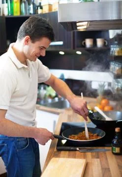 Young man preparing lunch Stock Photos