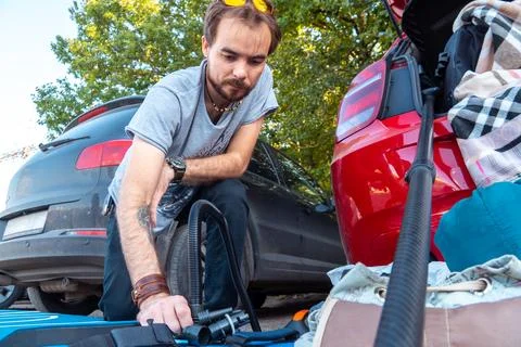 Young man preparing sup board for riding Stock Photos
