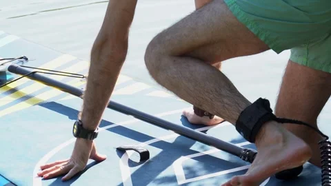 A young man preparing for supboarding Stock Footage 246838857