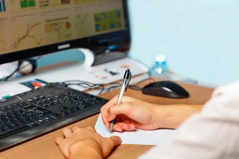 Young man preparing to take lecture notes, working at the computer, e-learnin Stock Photos