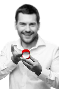 Young man presenting something in a small box Stock Photos