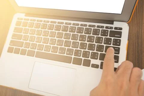 Young Man press the button enter working on labtop, Close-up finger pressing Stock Photos