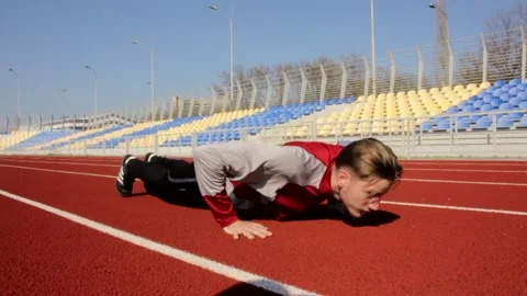 Young man press push up outdoor sport exercise working out on spring sunny day Stock Footage 137542641