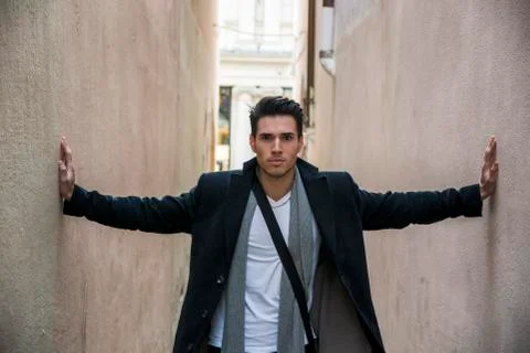 Young man pressed between two walls. Oppression, anxiety Stock Photos