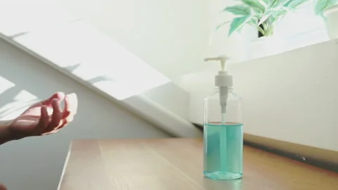 Young man presses a bottle of alcohol, Seventy percent alcohol-based gel is u Stock Footage 147537161