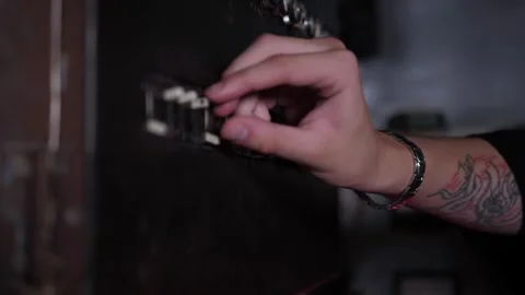 A young man presses buttons on an old factory control panel. Stock Footage 310655833