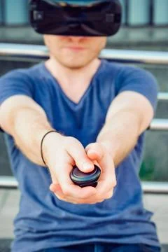 Young man pressing the control panel button enjoying virtual reality glasses Stock Photos