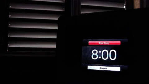 Young Man Pressing Snooze Button on Early Morning Digital Alarm Clock. 4K. Stock Footage 205147495