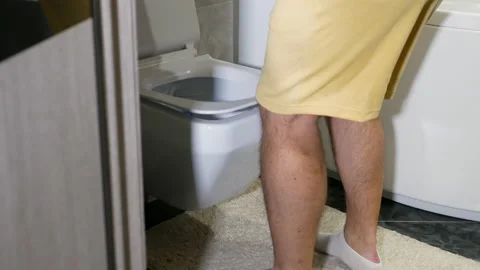 Young man with a problem of the genitourinary system. A man runs in the toilet Stock Footage 225156873