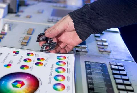 Young man in the process of offset printing and color correction Stock Photos