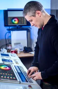 Young man in the process of offset printing and color correction Stock Photos